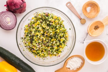 seasoned diced veggies in a glass bowl.