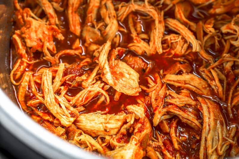 shredded instant pot chicken taco meat in an instant pot.