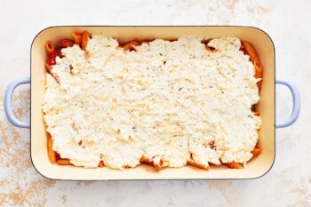 layer ricotta cheese and pasta into the baking dish