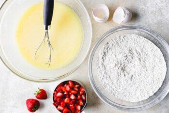 overhead view of wet and dry ingredients for strawberry bread in separate bowls.