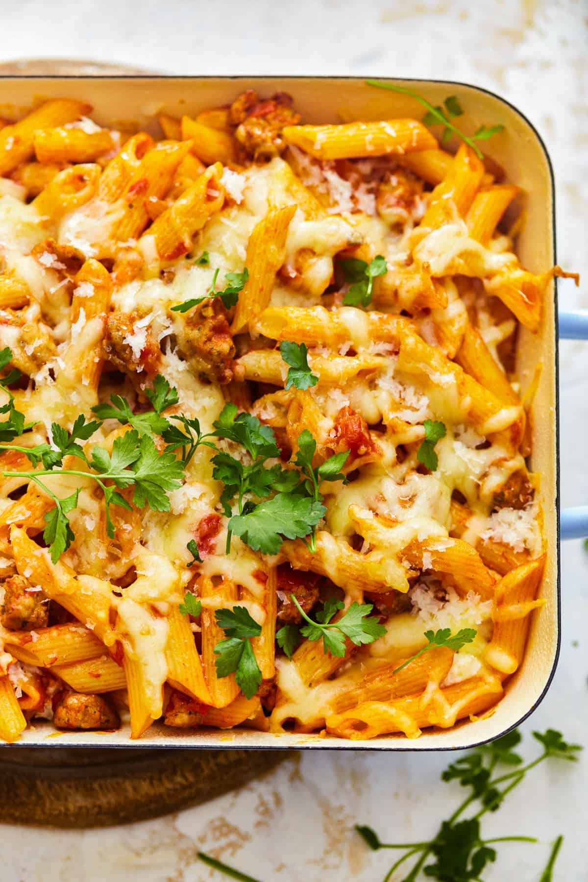 close up on a dish go baked mostaccioli pasta covered in cheese