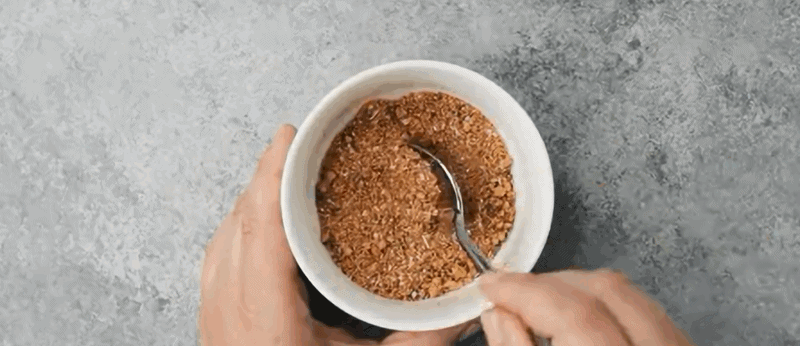 Seasoning mix for chicken in a white bowl with a spoon.