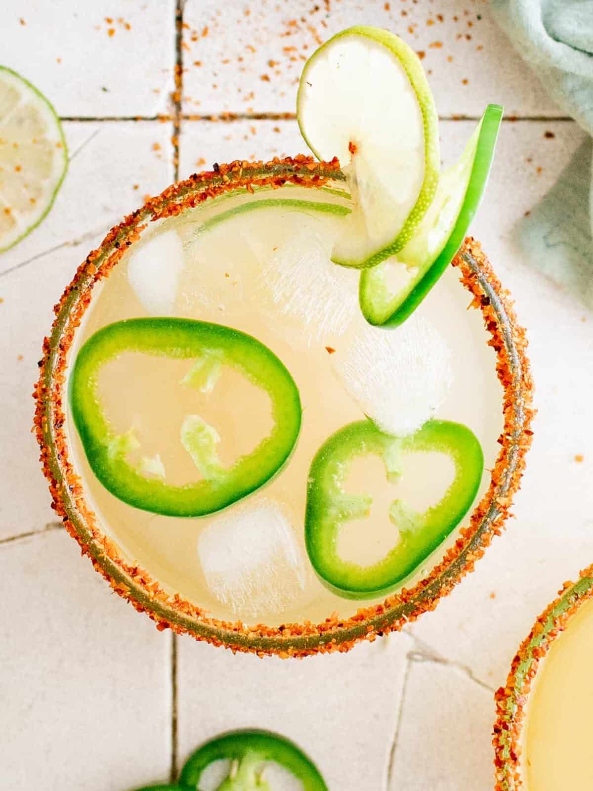 overhead view of a jalapeño margarita garnished with jalapeño slices