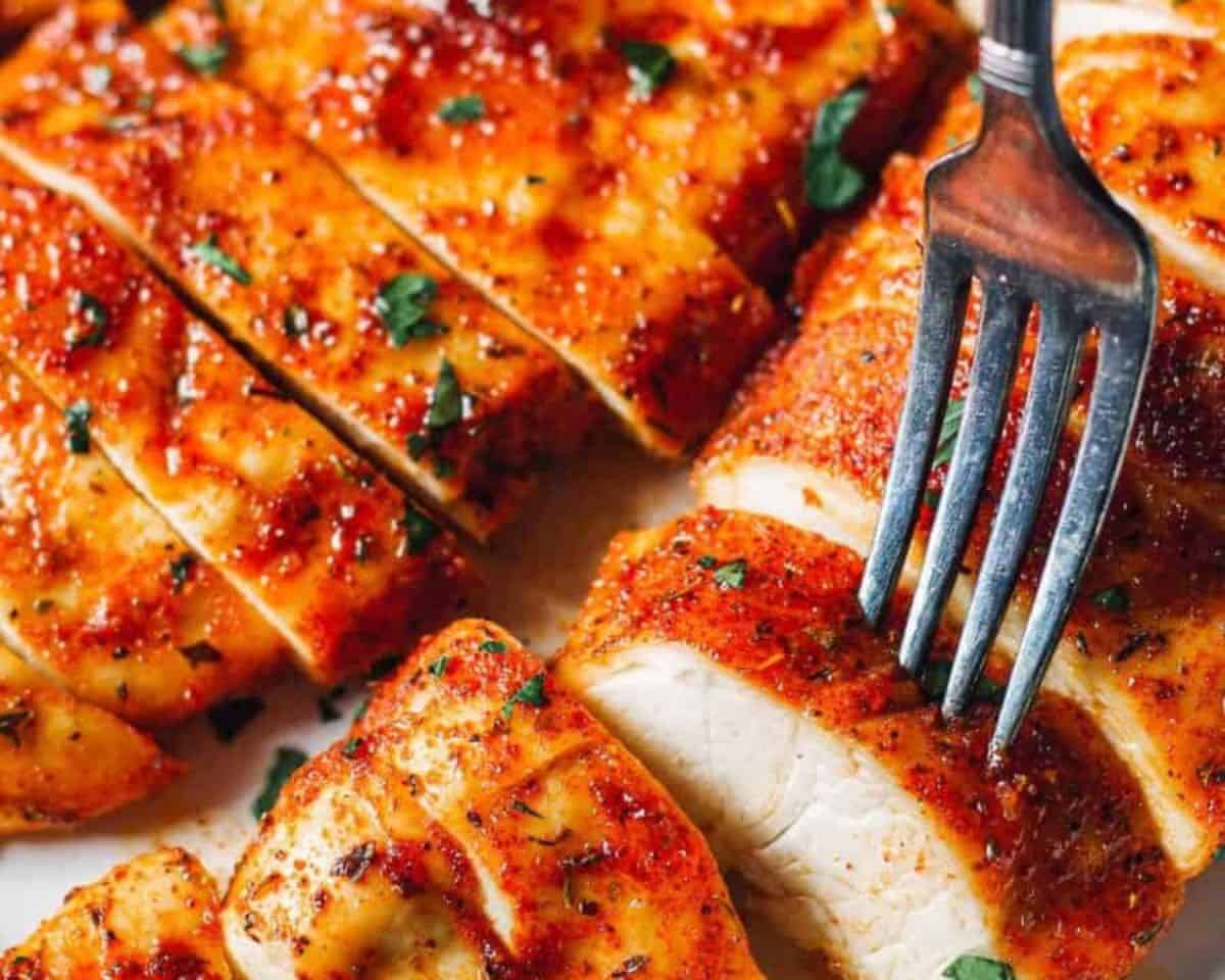 Juicy sliced baked chicken breasts topped with herbs and seasoning ready to serve - 14