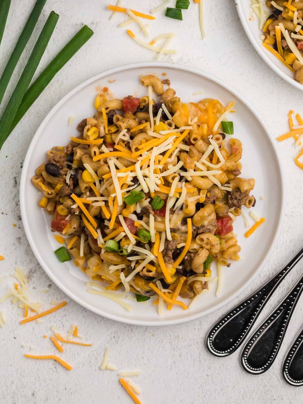 overhead view of a serving of taco mac and cheese on a white plate.