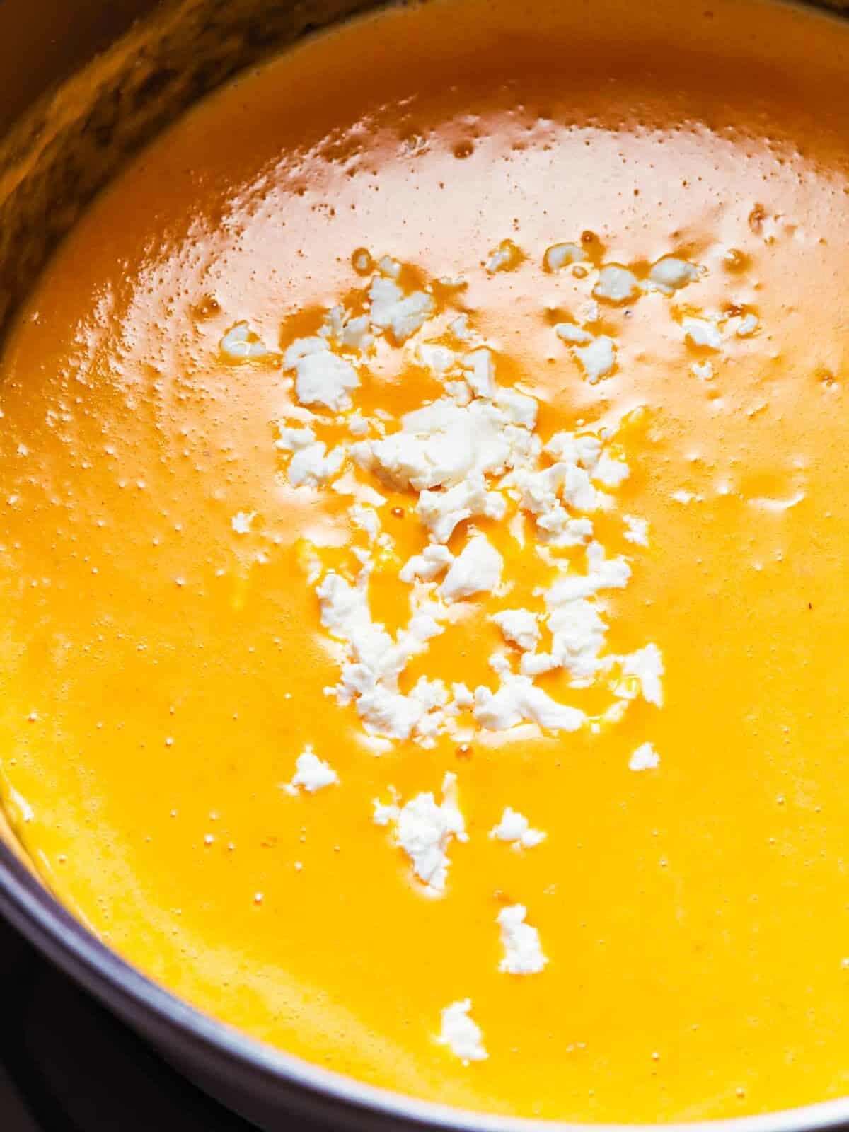 close up on a pot filled with beer cheese soup