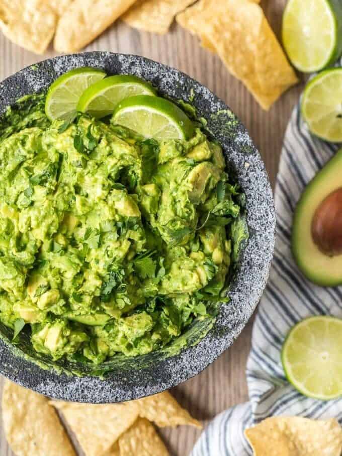 Best Guacamole Recipe ever in a bowl, surrounded by tortilla chips