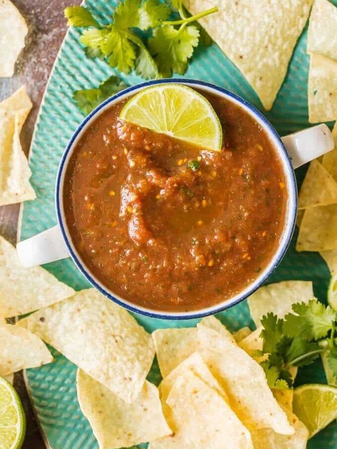 overhead view of a bowl of easy homemade salsa surrounded by tortilla chips