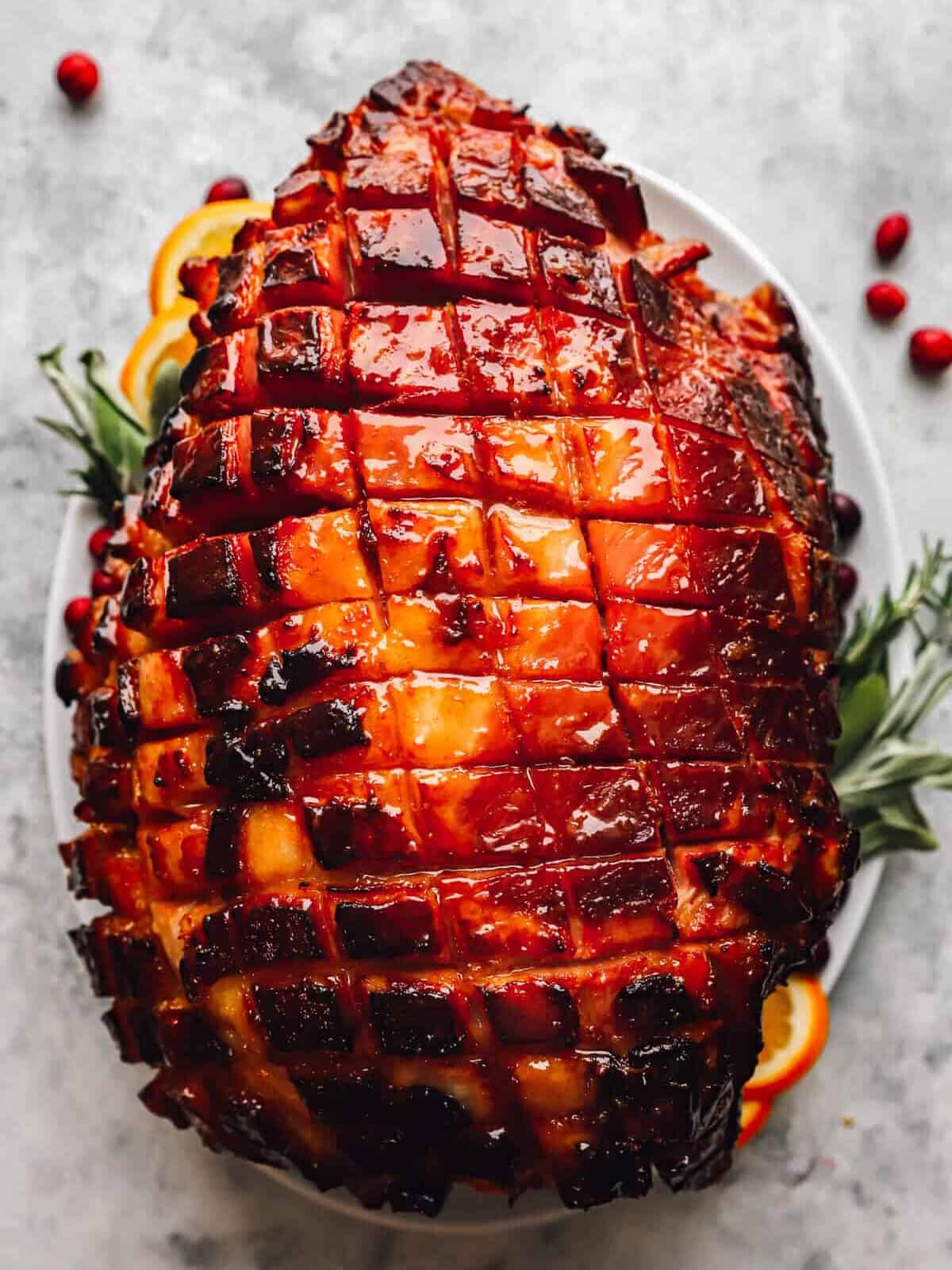 overhead view of a baked ham that has been scored and glazed