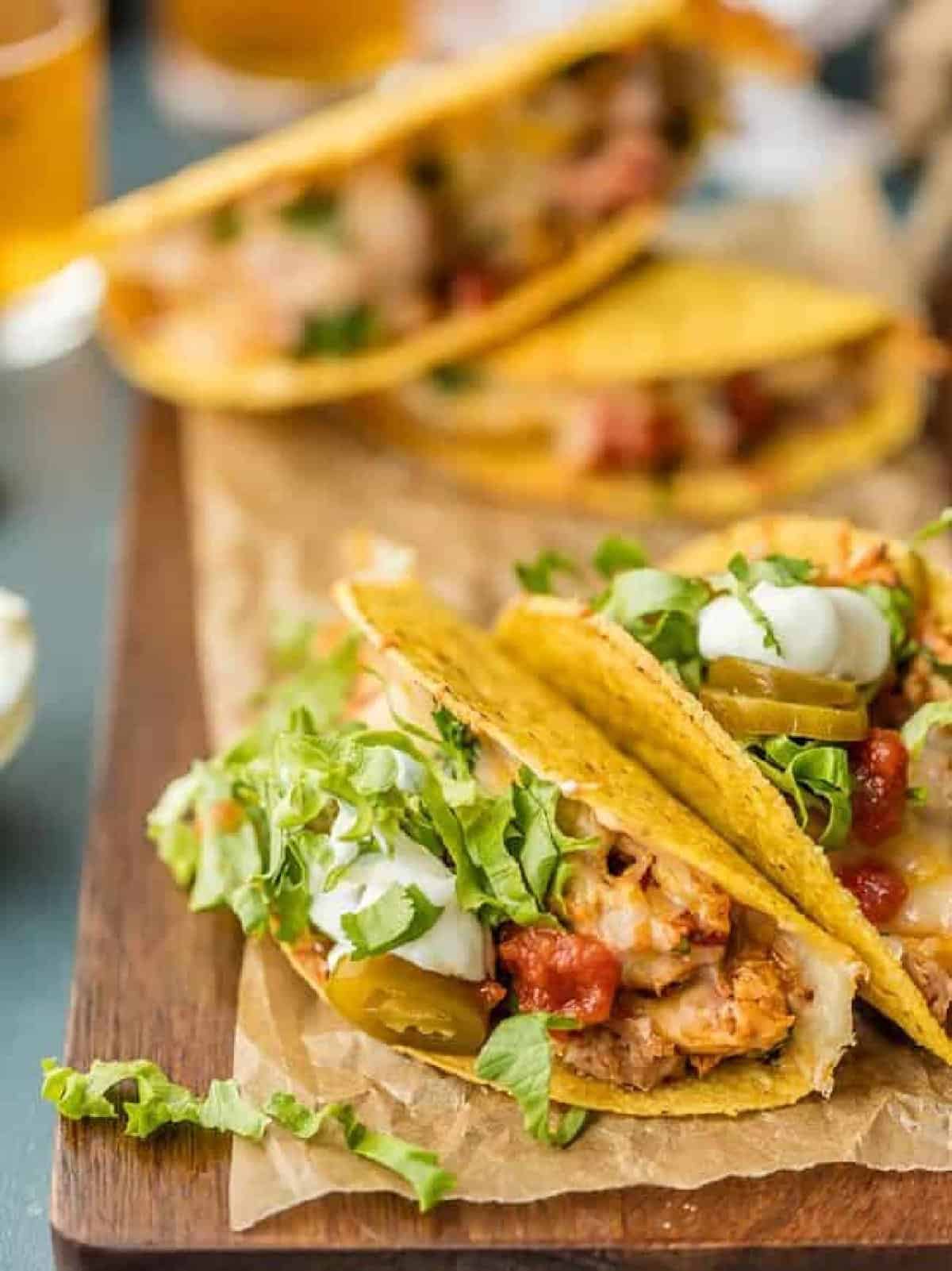 Delicious chicken tacos on a rustic cutting board.