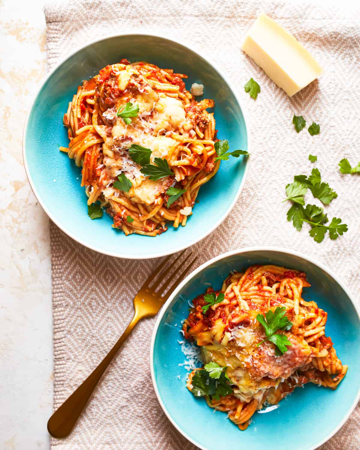 overhead view of 2 bowls of crock pot spaghetti casserole