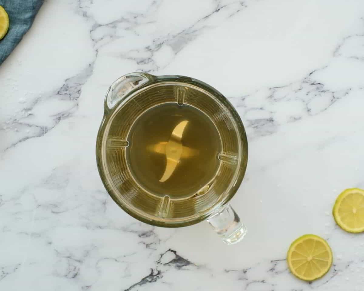Tequila, lime juice, Cointreau, and agave nectar added to a blender pitcher before blending frozen margaritas.