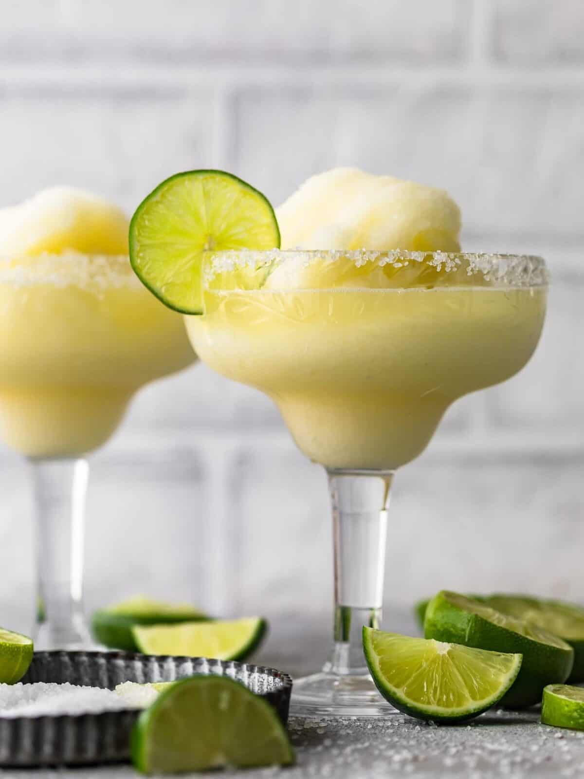 Two frozen margaritas served in glasses