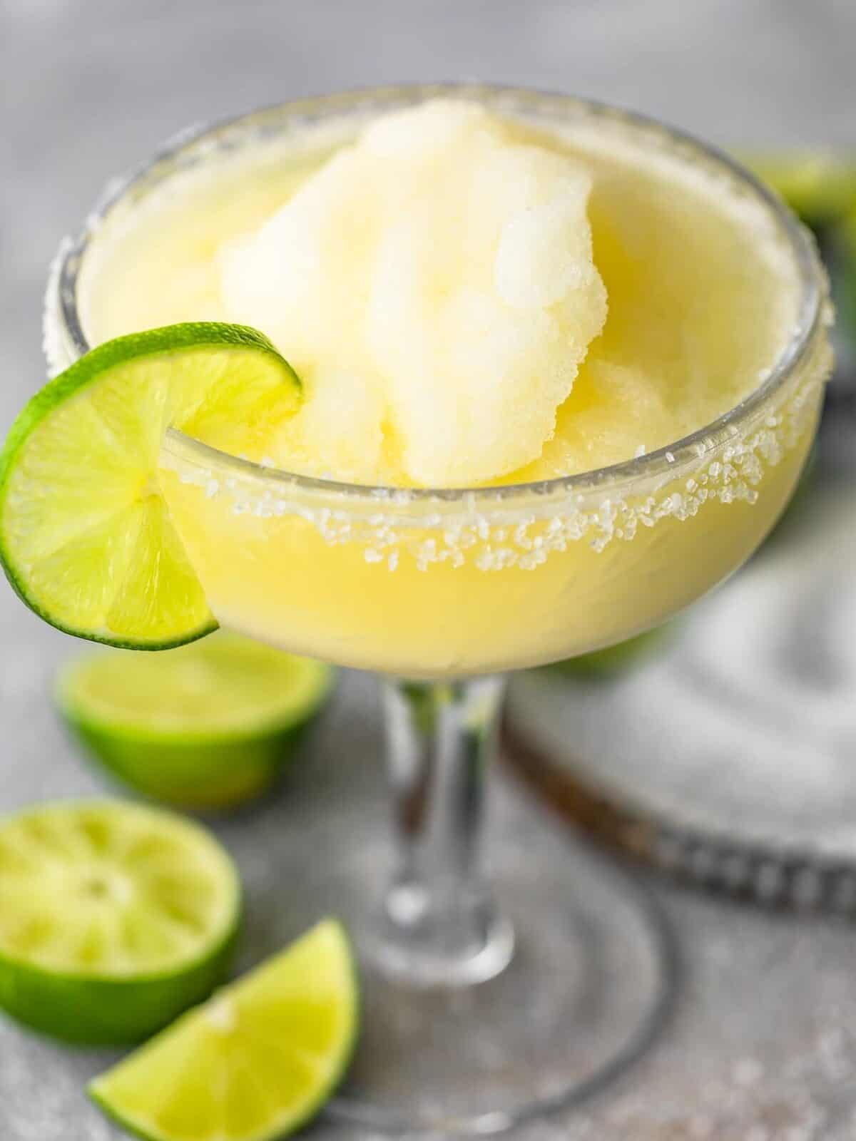 A margarita served in a glass with lime and salt