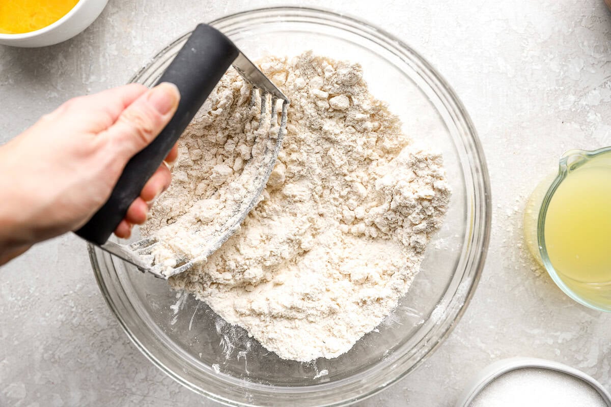 Cutting cold butter into gluten-free flour mixture to make lemon bar crust