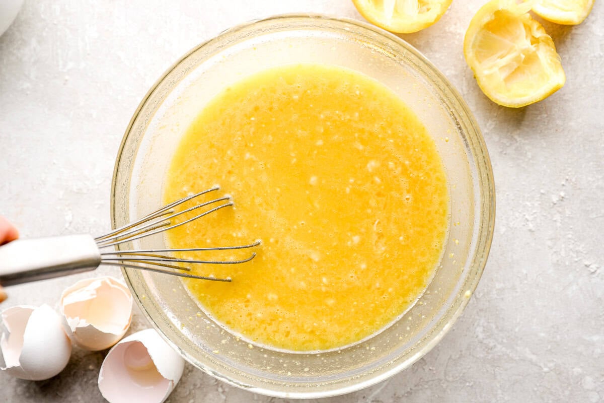 Whisking lemon juice, sugar, and eggs together for lemon bar filling