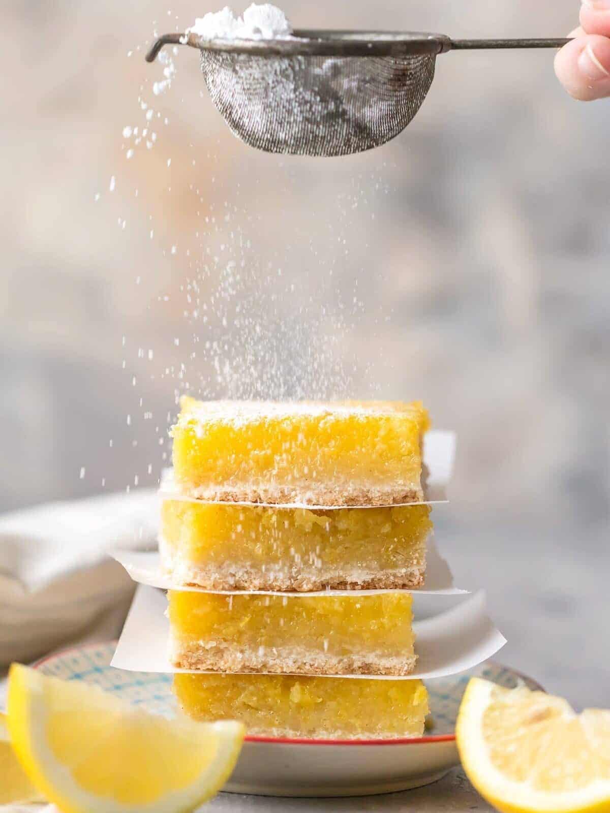 lemon squares stacks and garnished with powdered sugar