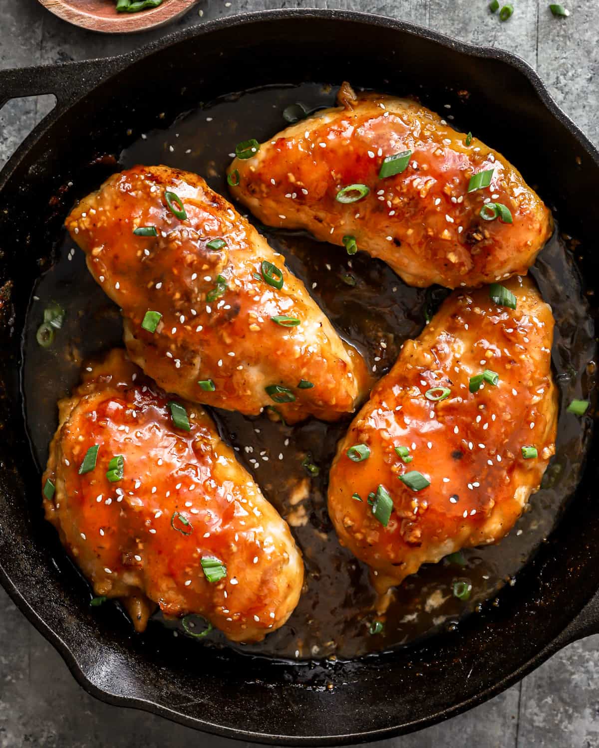 honey glazed chicken breasts in a cast iron skillet.