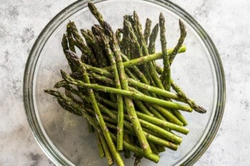 asparagus and seasonings in a glass bowl.