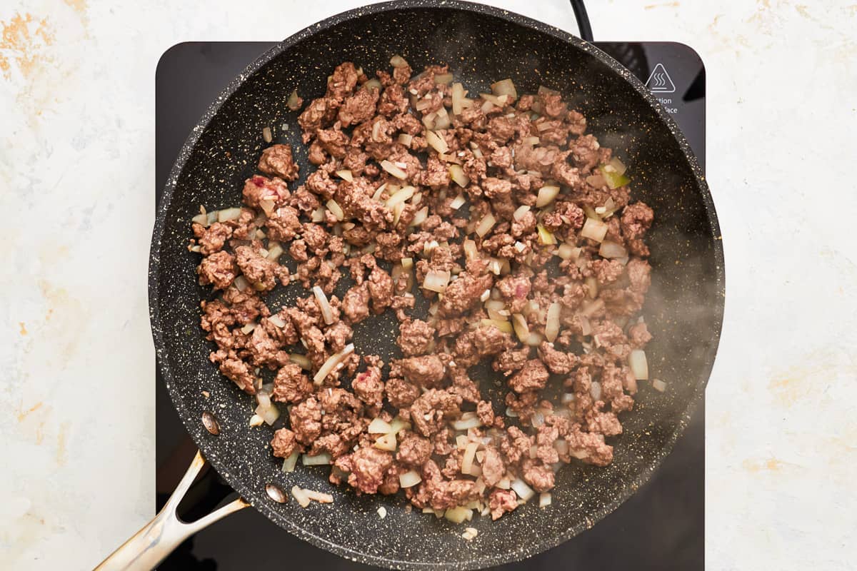 Ground beef cooking in a pan.