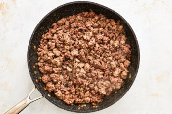 ground beef in a frying pan.