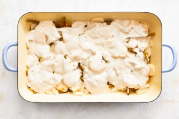 casserole topped with sour cream and cream of celery soup mixture