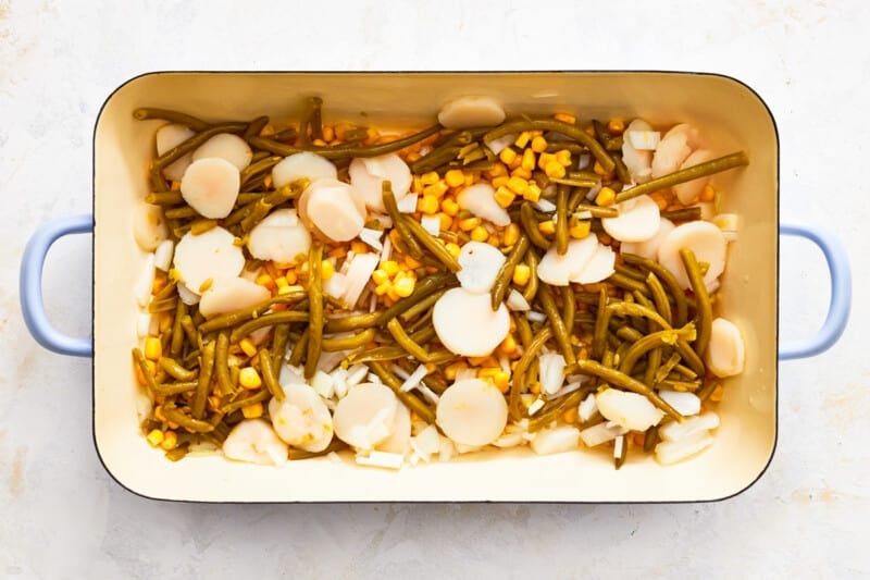 green beans, corn, and water chestnuts layered in a casserole dish