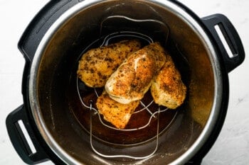 4 chicken breasts on a trivet in an instant pot.