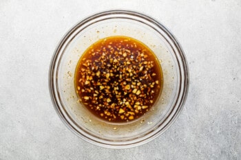 a bowl of sauce with sesame seeds in it.