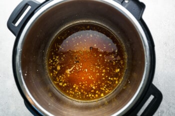 an instant pot filled with a brown sauce.
