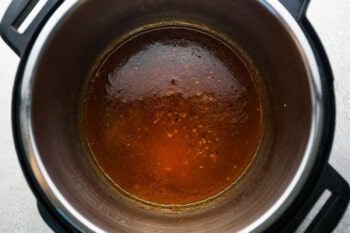 an instant pot filled with a brown sauce.
