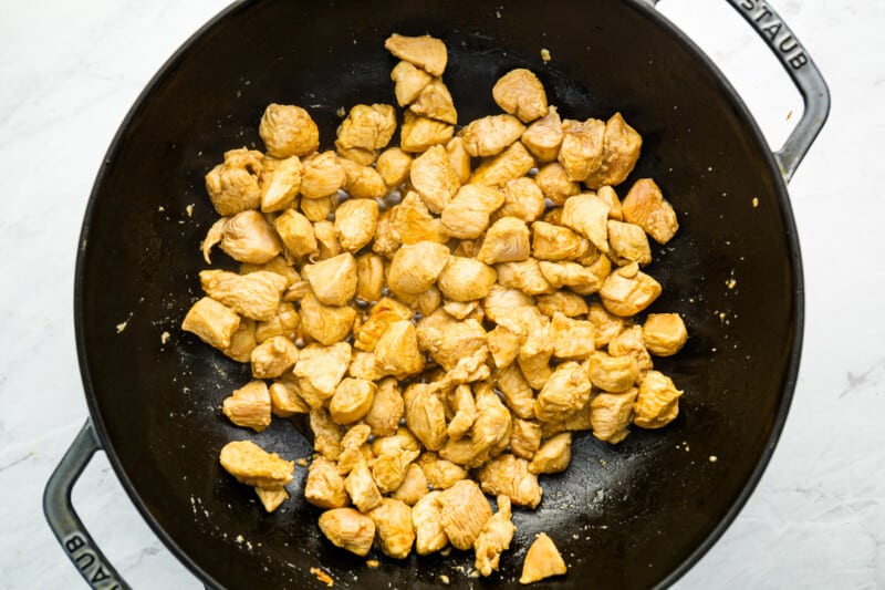 fried chicken in a skillet on a marble countertop.