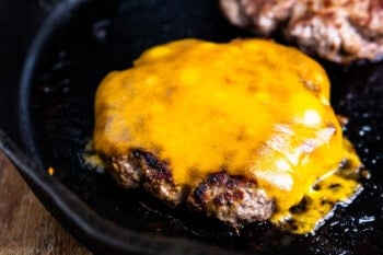 close up in a cheeseburger in a skillet