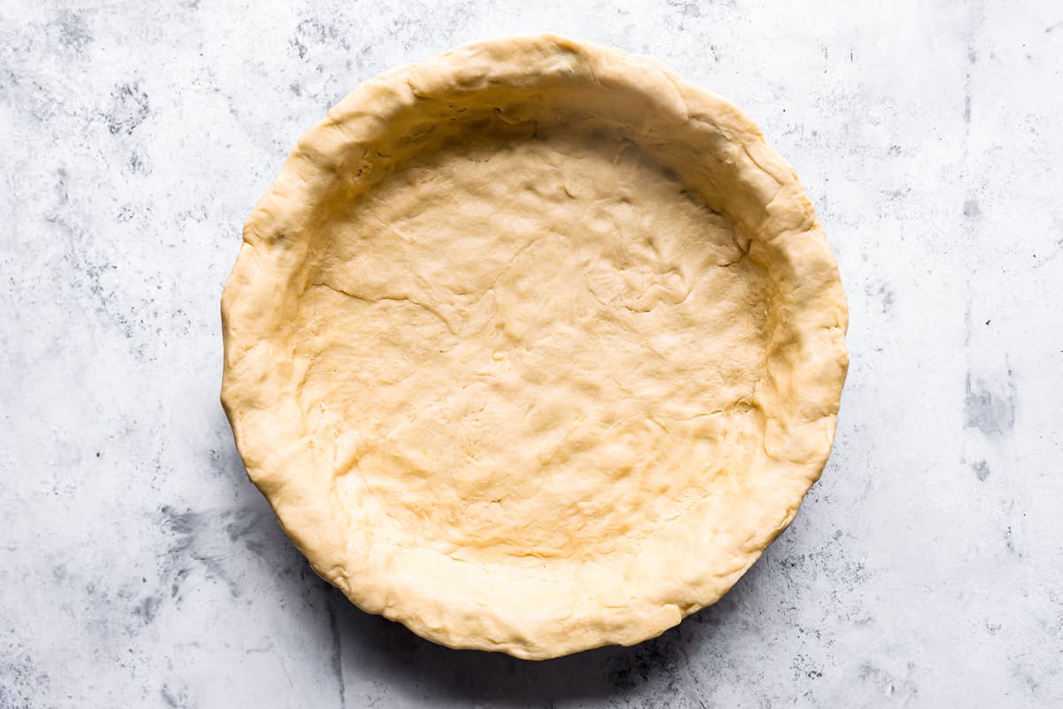 Crescent roll dough pressed into a pie pan.