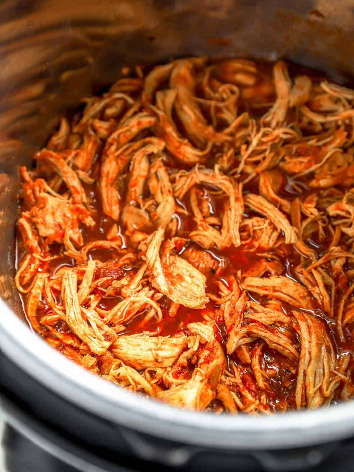 three-quarters view of pressure cooker chicken taco meat shredded in an instant pot.