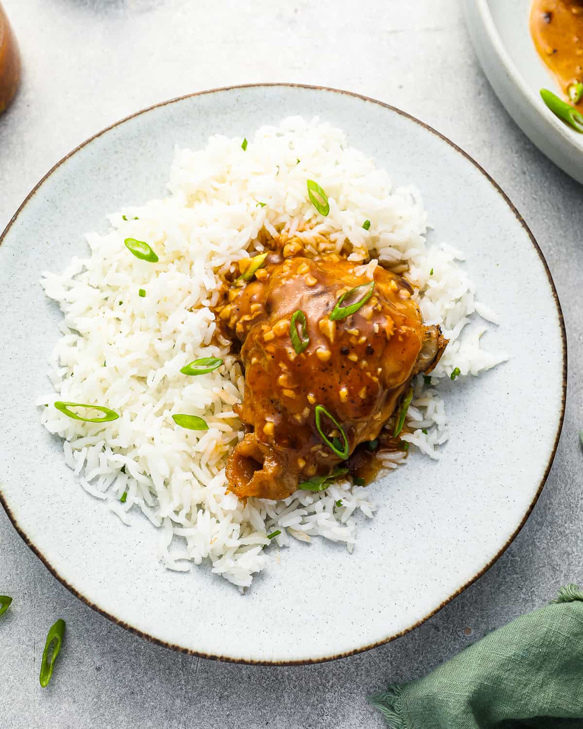 pressure cooker chicken thighs with white rice on a plate.