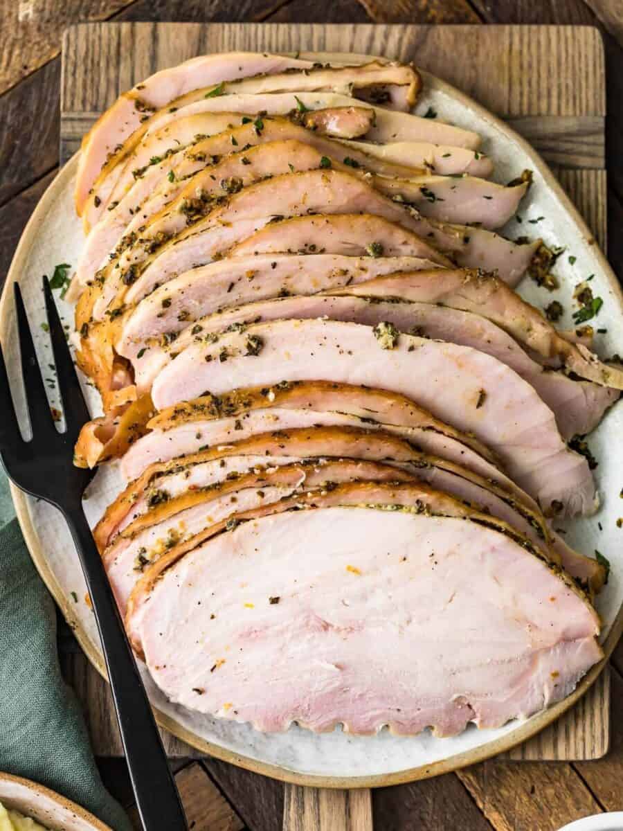 juicy smoked sliced turkey breast on a cutting board