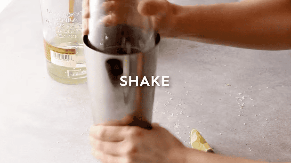 shaking individual margaritas in a cocktail shaker.