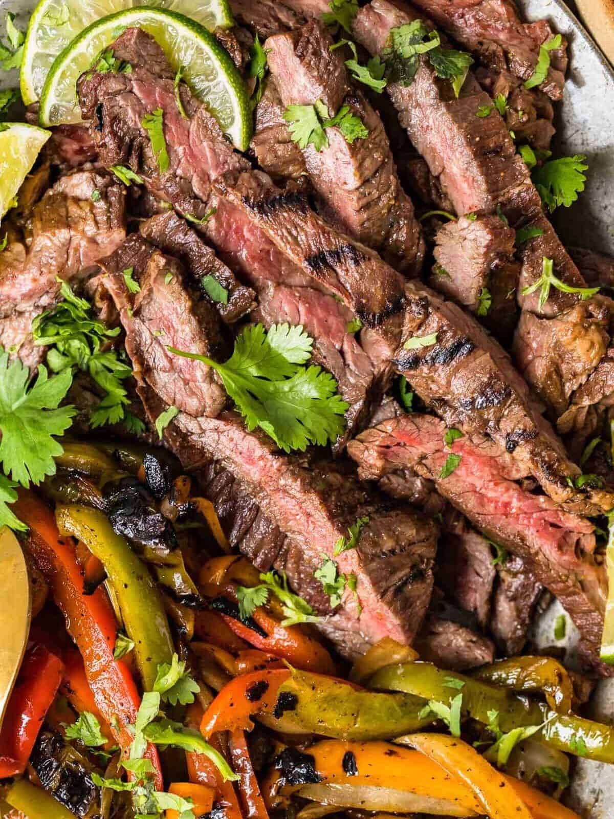 close up on strips of fajita steak and veggies