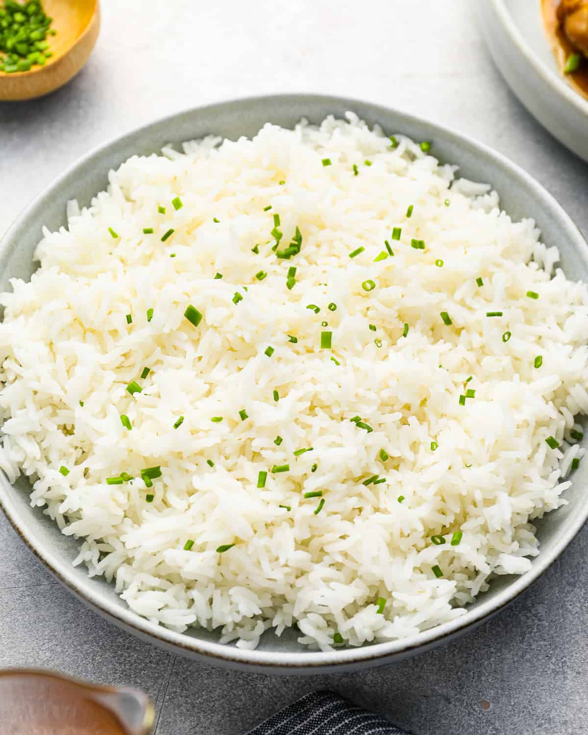 three-quarters view of perfect basmati rice in a white bowl.