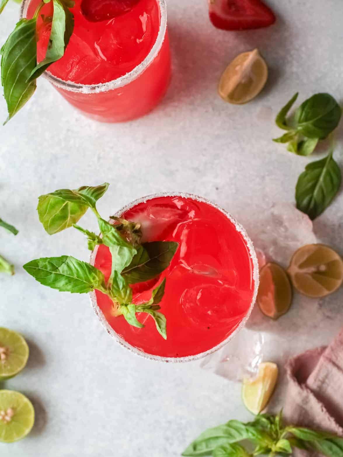 overhead view of 2 strawberry basil margaritas.