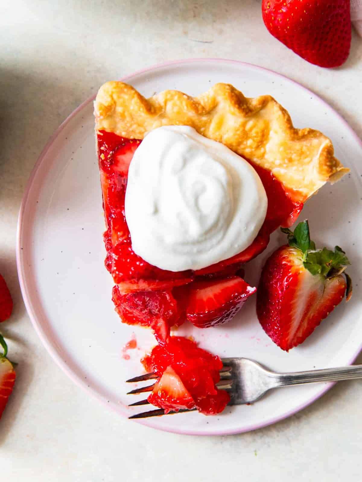 up close slice of strawberry jello pie with whipped cream