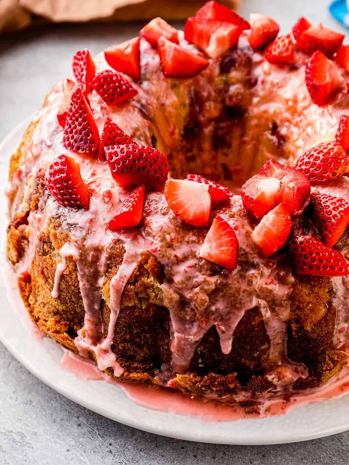 side shot of strawberry pound cake with strawberry glaze