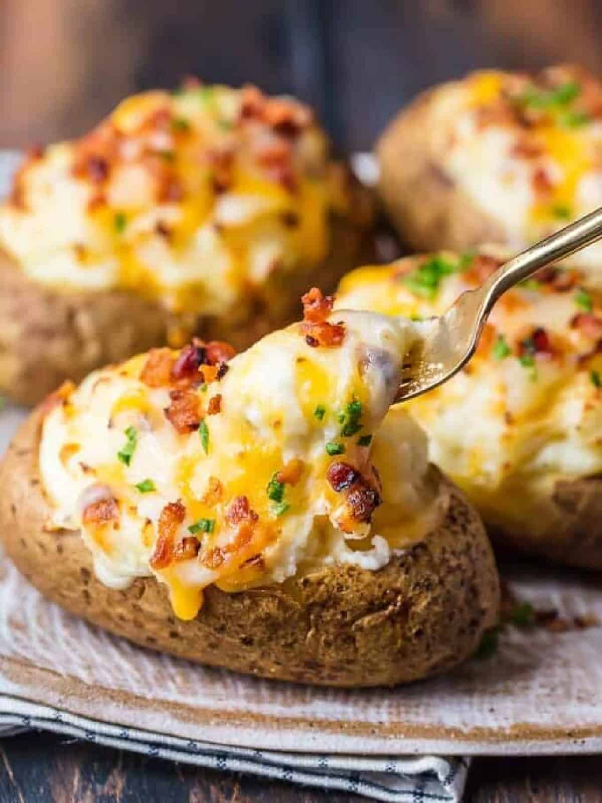 fork lifting up cheese on twice baked potato