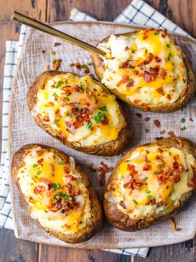  twice baked potatoes topped with cheese, scallions, and bacon