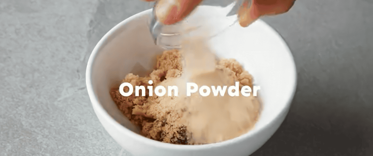 Combining the seasonings in a white bowl.