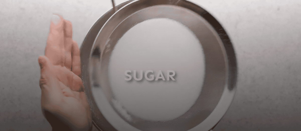 Sifting dry ingredients into a bowl.