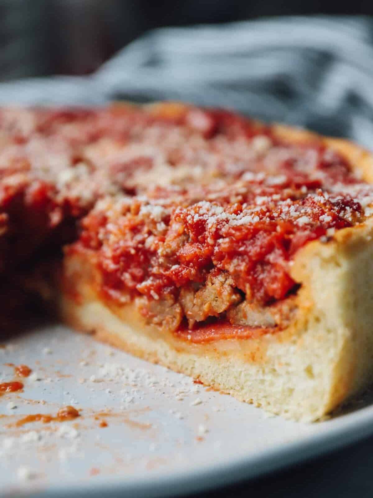close up of a sliced chicago deep dish pizza.