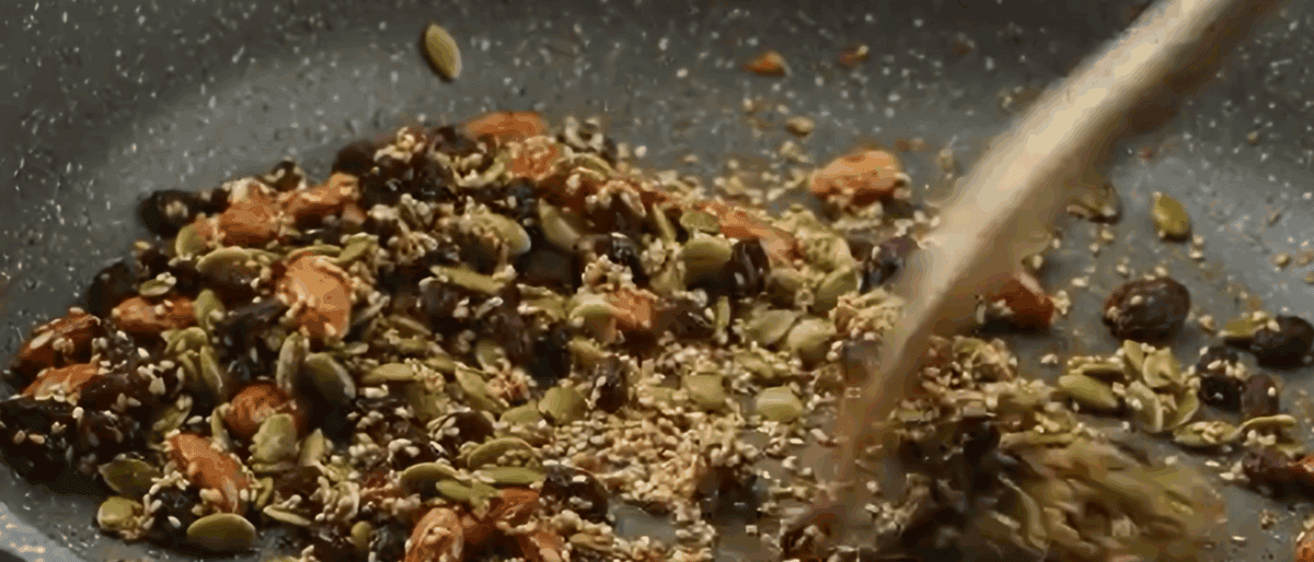 Toasted nuts and seeds in a skillet.