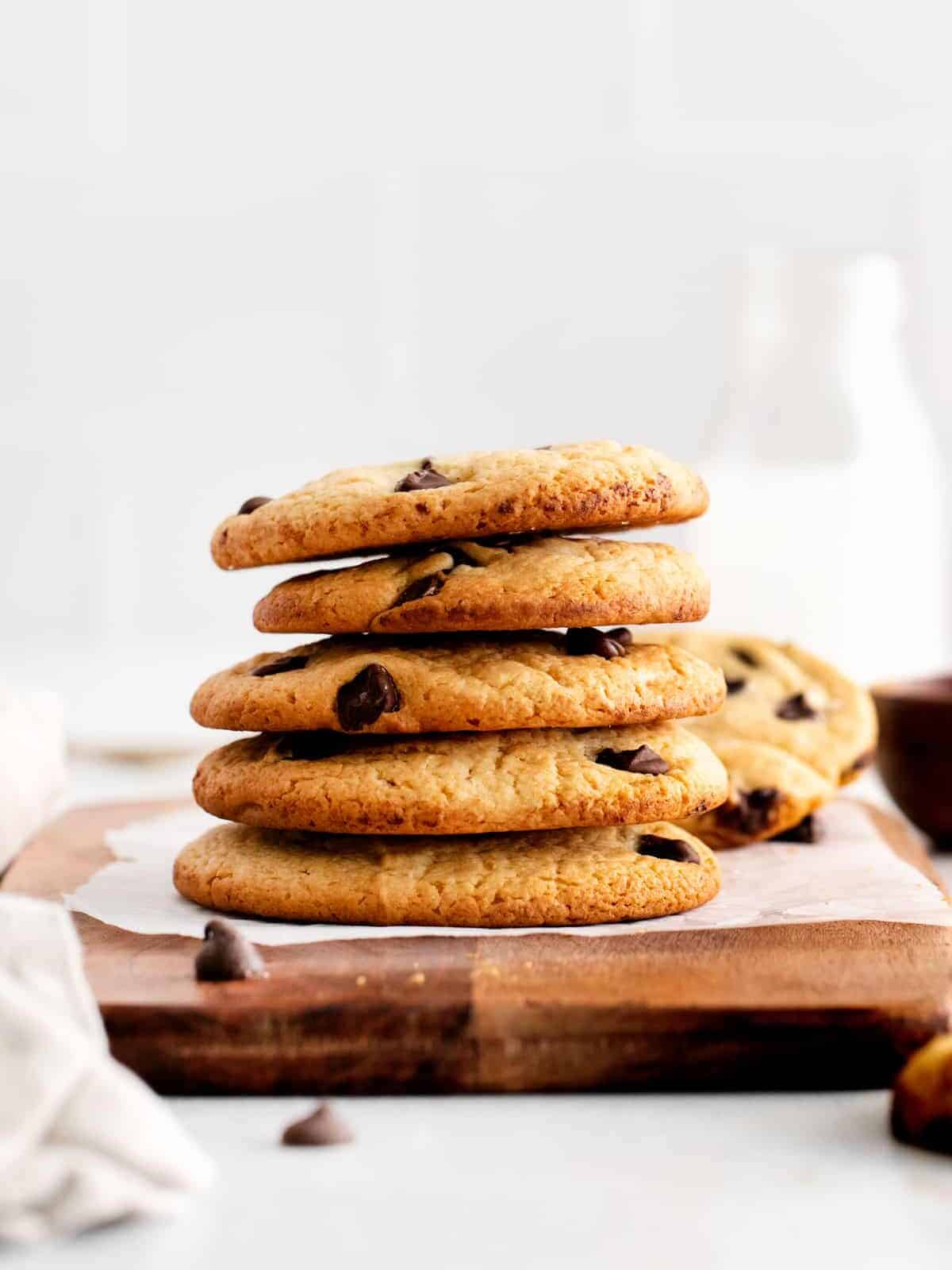 a stack of 5 cake mix chocolate chip cookies on a cutting board.